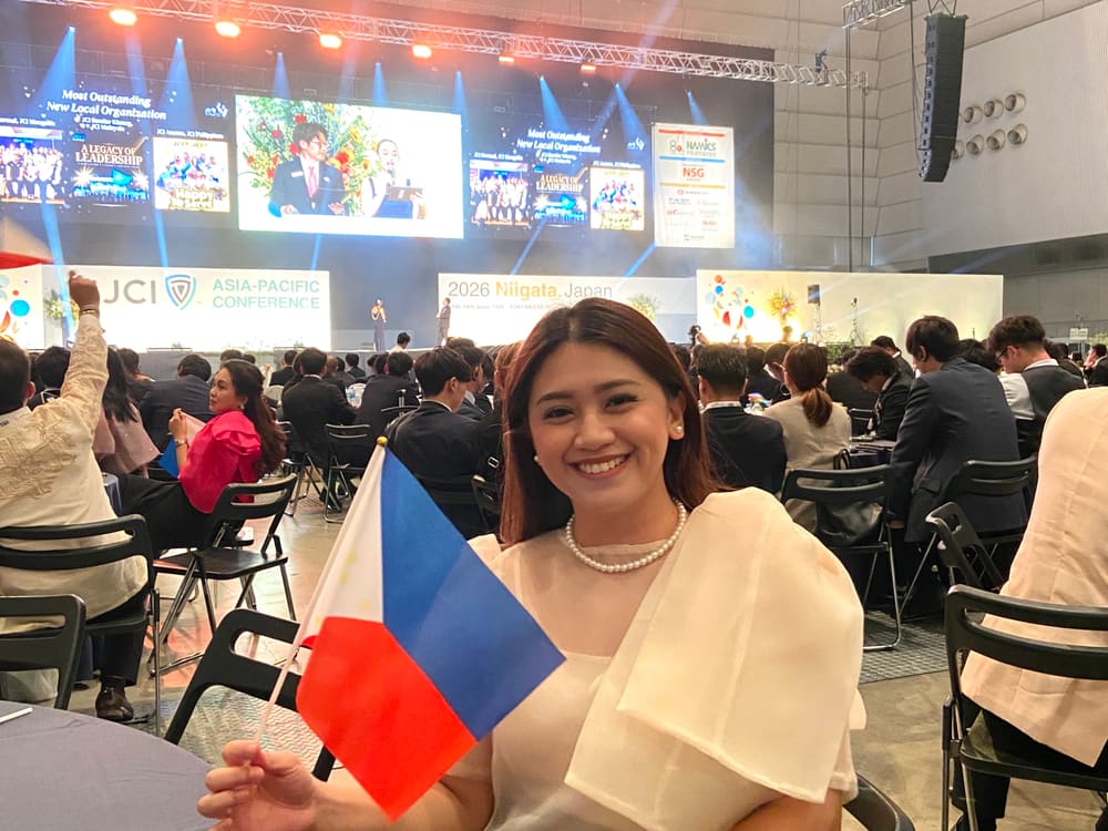 Holding the Philippine flag at the conference