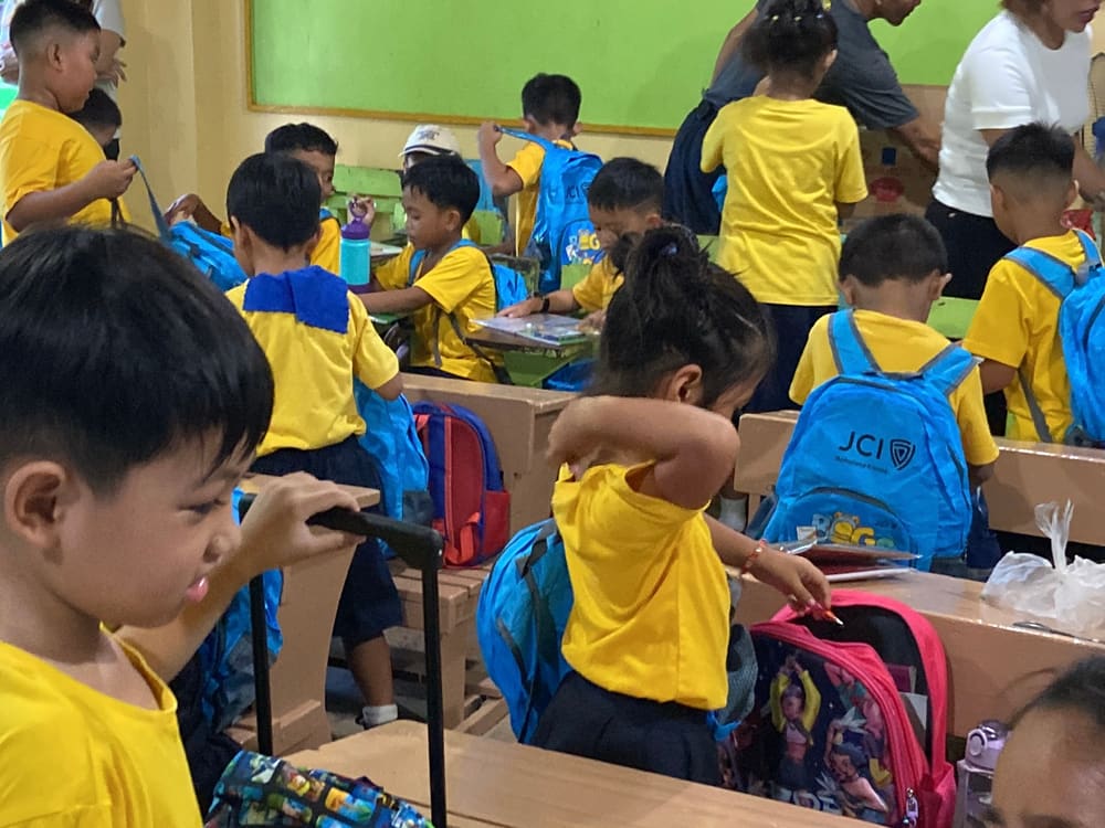 Students wearing their new blue JCI backpacks
