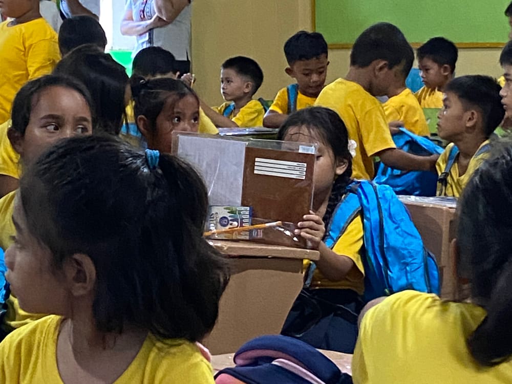 Learners at their desks with new school supplies