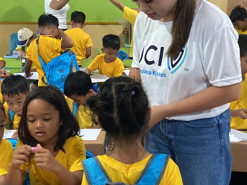 A member helping a child during distribution
