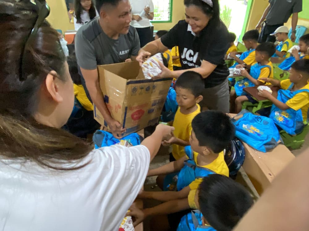 Volunteers distributing supplies from boxes