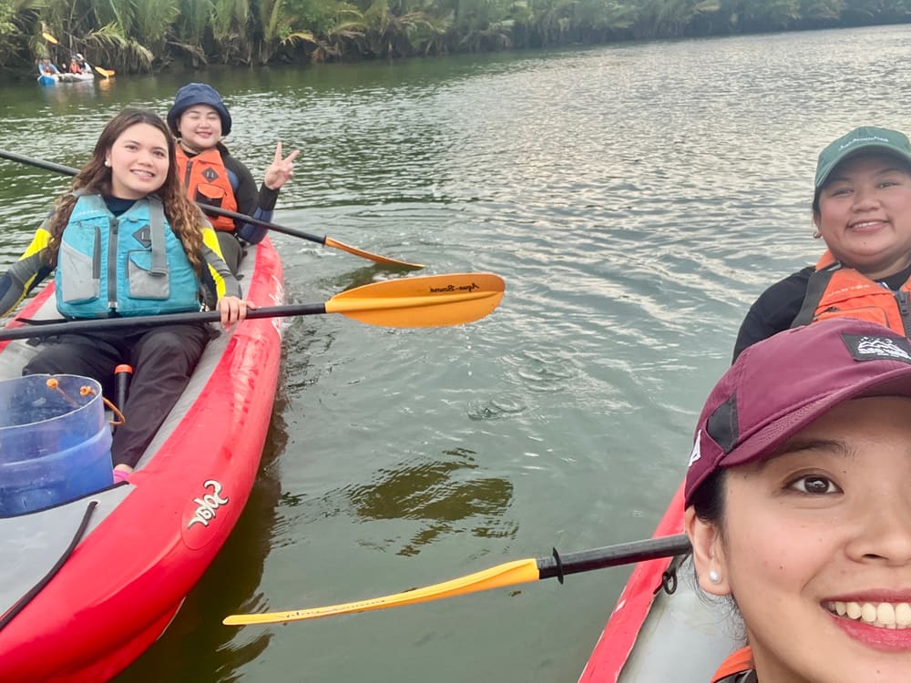 Members paddling kayaks during a river reboot