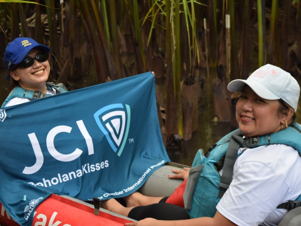 JCI Boholana Kisses flag raised from a kayak